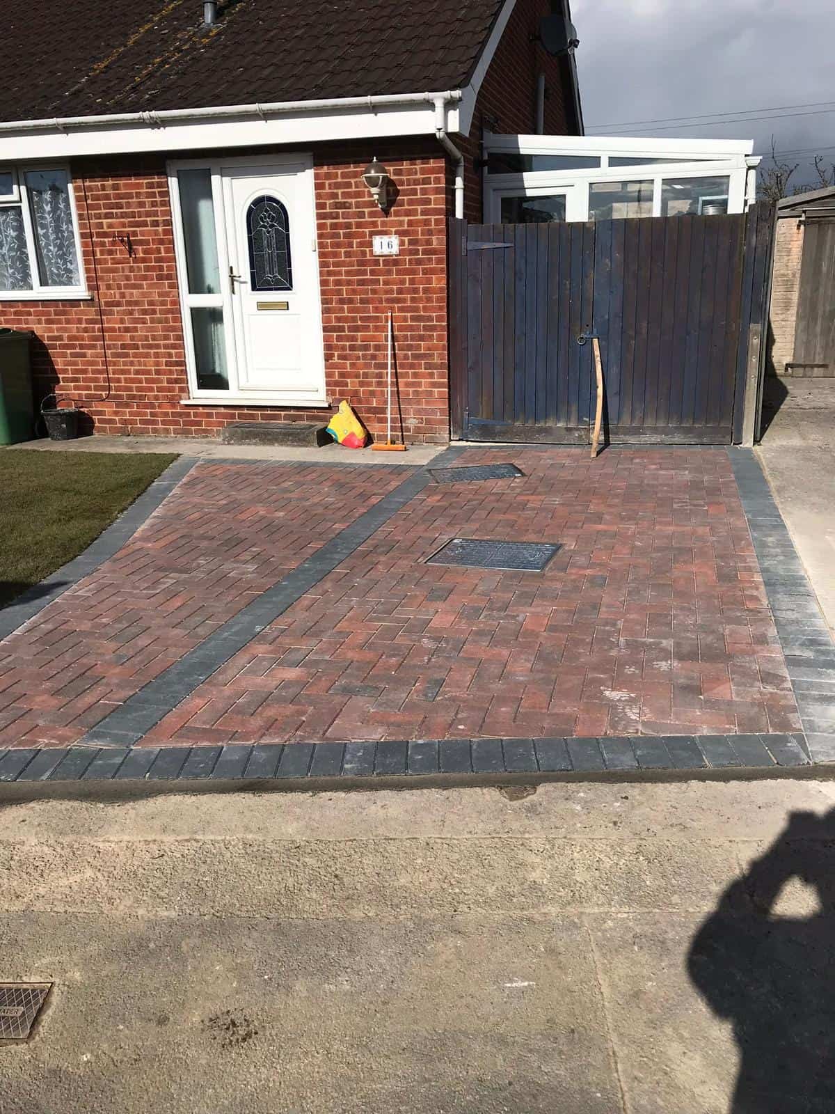 New block paving driveway with drainage channel alongside a Gloucestershire property