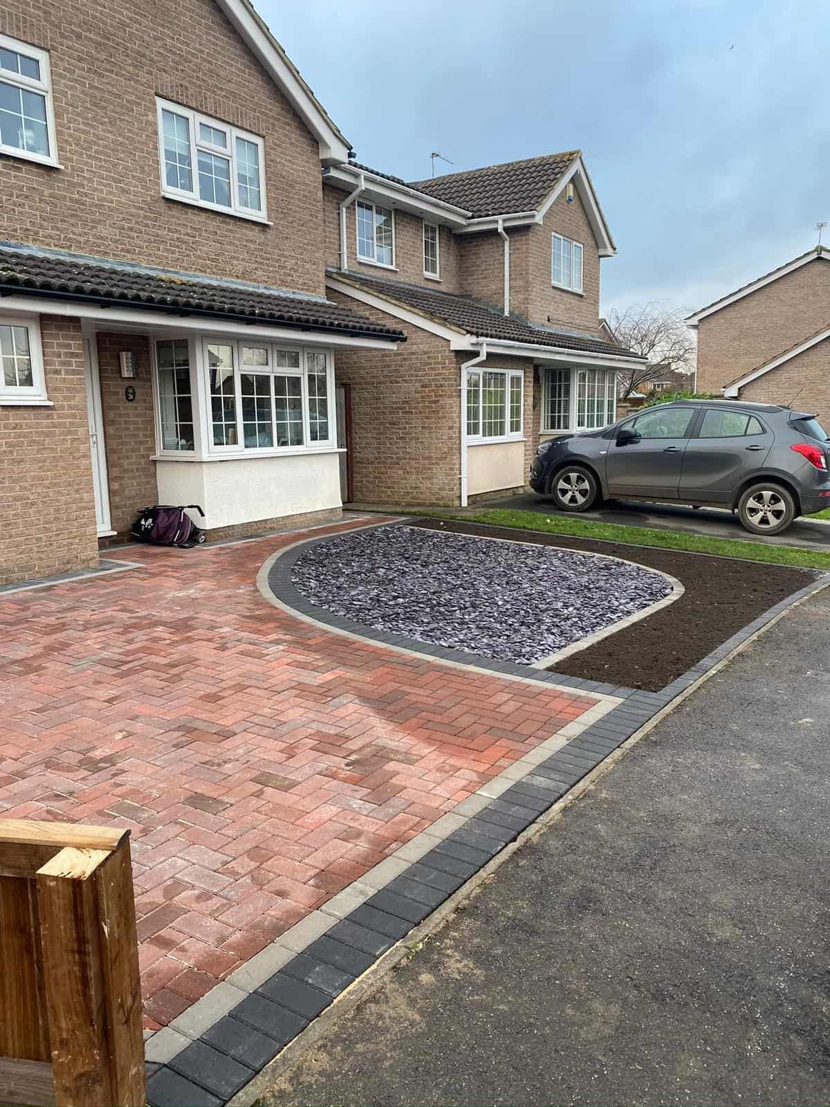 Charcoal and buff block paved driveway with contrasting border in Gloucestershire