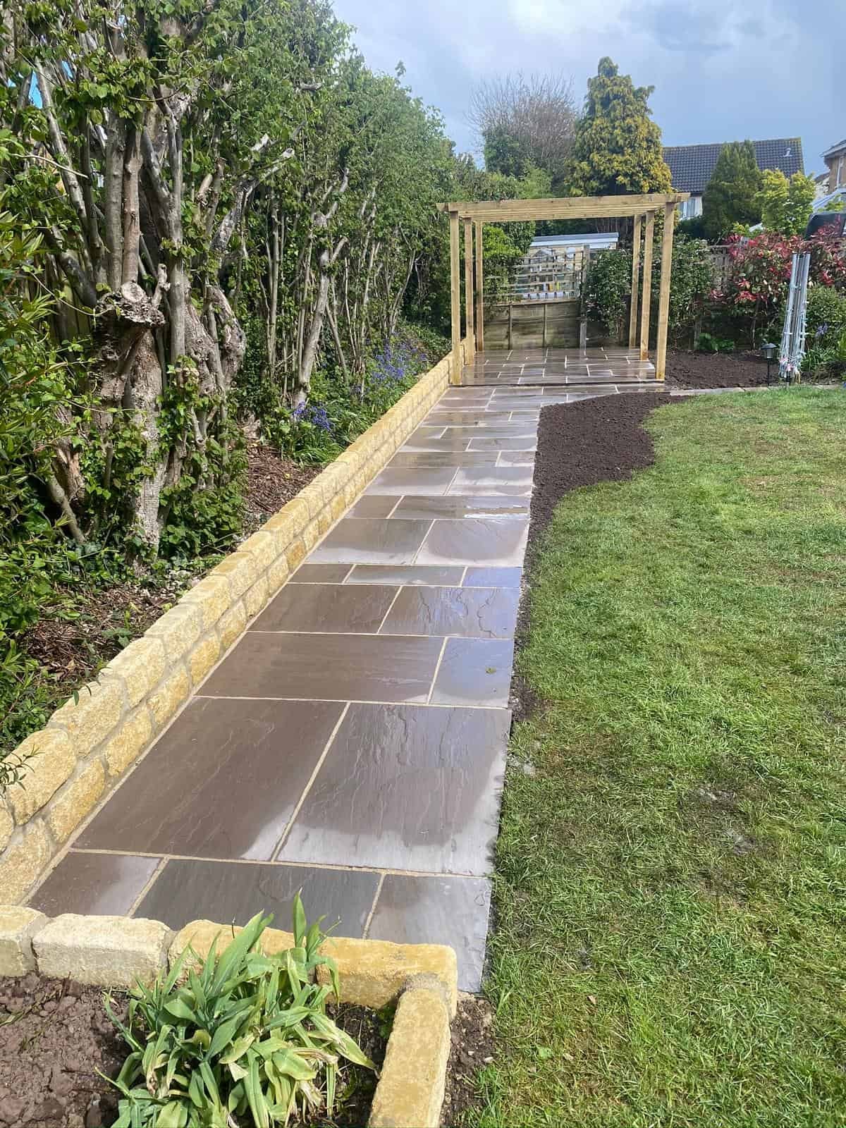 Brick retaining wall with planting behind, built in Gloucestershire by SJS Landscaping & Gardening