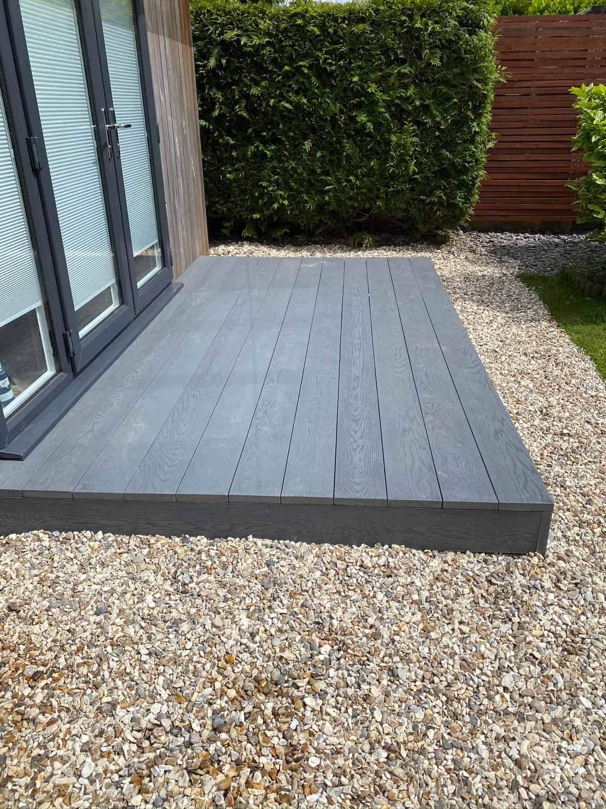 Composite decking area with gravel in Gloucestershire garden