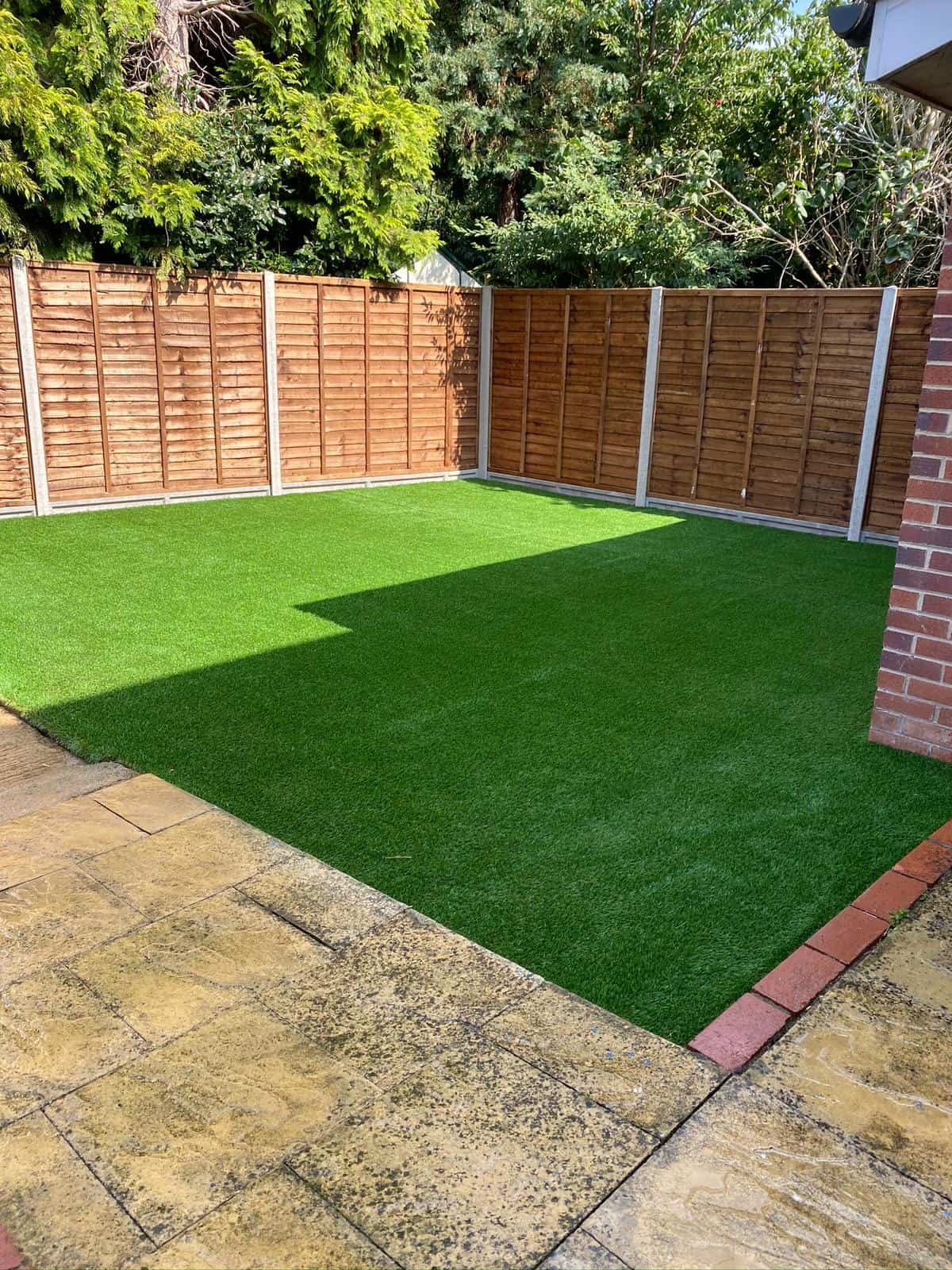 Close-up of artificial grass with neat edging installed in a Gloucestershire garden