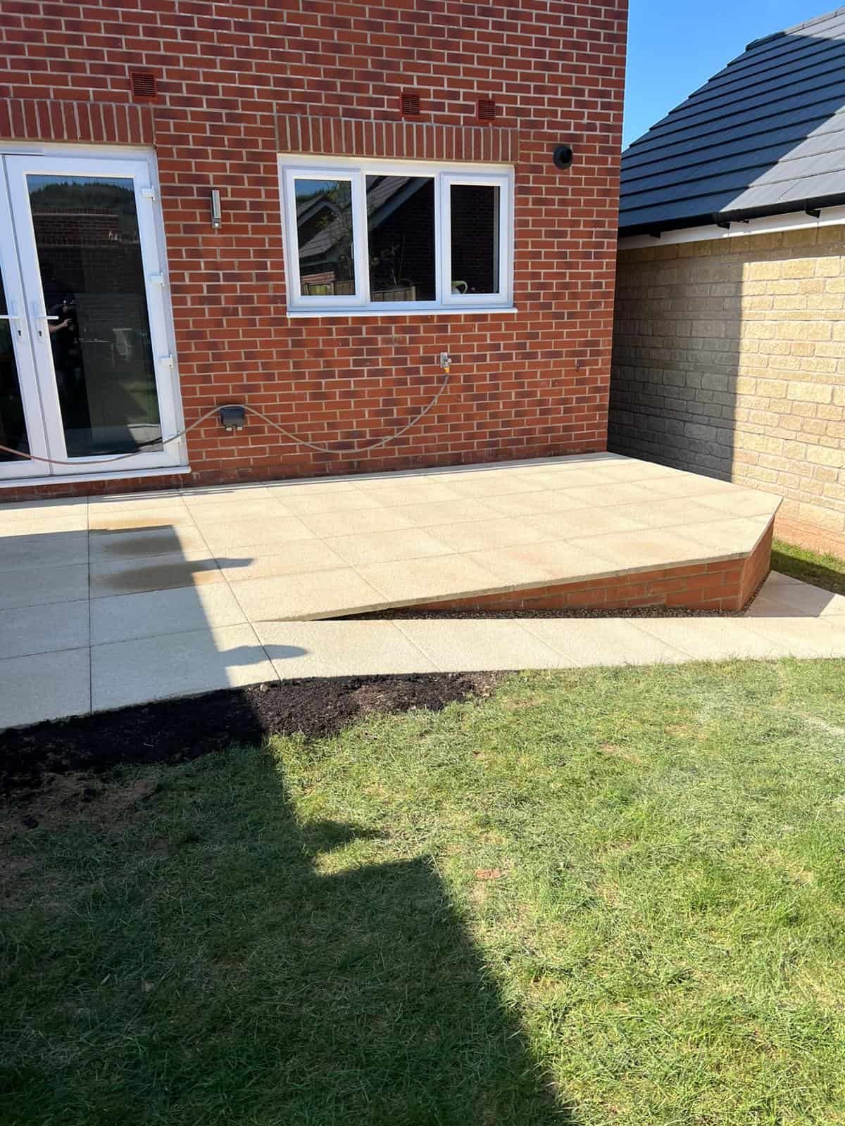 Brickwork & garden walls Gloucester Retaining wall holding back a sloped garden bed in Gloucestershire